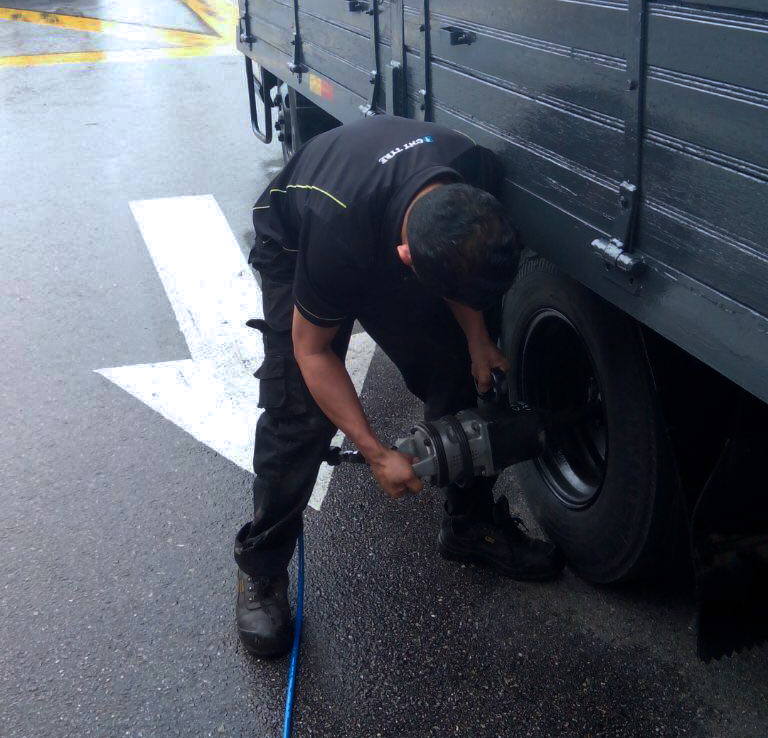 Professional tyre technician at work